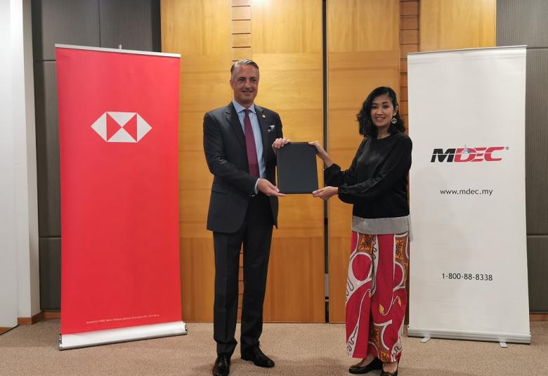 STUART MILNE (left) and Surina Shukri (right) at the signing ceremony to establish the first MoU between HSBC Malaysia and MDEC focused on accelerating the adoption of technology among SMEs, large local corporates and multinational companies in Malaysia. 